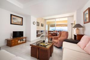 a living room with a couch and a table at Port de Pollenca Esmeralda 3 in Port de Pollensa