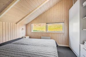 a bedroom with a large bed and a window at SJ225-Hejls-Humlevaenget-6 in Hejls
