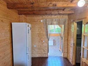 a refrigerator in a room with wooden walls at Садиба Сузір'я in Vorokhta