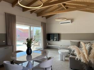 a living room with a table and a couch at Zefy's Scenic Oasis in Pesádha