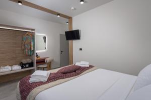 a bedroom with a bed with towels on it at Costa Blu Mare in Haraki