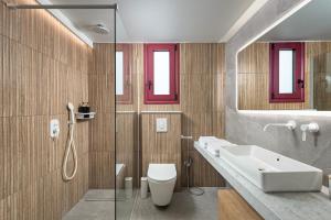 a bathroom with a sink and a toilet and a shower at Costa Blu Mare in Haraki