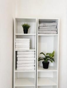 a white towel rack with towels and a plant at Kinneret Royal Penthouse in Tiberias +64 photos
