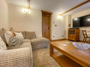 a living room with a couch and a coffee table at The Granary in Little Chart