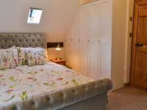 a bedroom with a bed with a large white closet at The Granary in Little Chart +7 photos