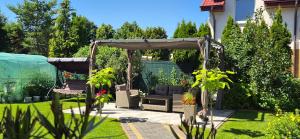 a garden with a gazebo in a yard at Villa Rekin in Grzybowo