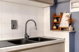 a kitchen counter with a sink in a kitchen at Dimora il Respiro di Pisa in Pisa +28 photos