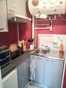 a small kitchen with a sink and a stove at STUDIO 100 m PLAGE in Le Portel