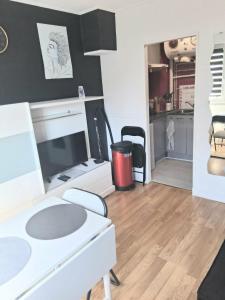 a living room with a white desk and a table at STUDIO 100 m PLAGE in Le Portel
