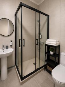 a bathroom with a shower and a toilet and a sink at Casa Durán Alicante in Alicante +13 photos