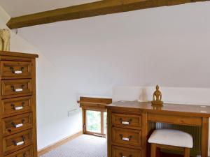 a bedroom with a wooden desk and a dresser at Bay - E4482 in Catfield