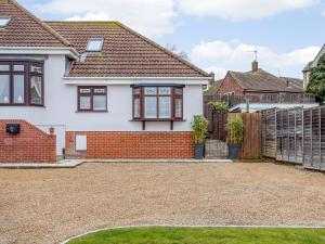 a white house with a brick driveway at Vineyard's Apartment - Uk36748 in Ely +10 photos
