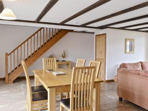 a dining room with a table and chairs and a couch at Mint - E4322 in Catfield