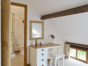 a bathroom with a white dresser and a mirror at Mint - E4322 in Catfield