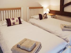 two beds in a room with towels on them at Mint - E4322 in Catfield +6 photos