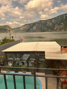 a house with a deck and a body of water at CASA DAVID in Dubova