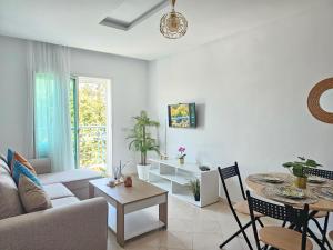 a living room with a couch and a table at Cabo Alegre in Martil
