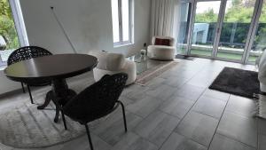 a living room with a table and chairs at Lora Gardens in Chartwell