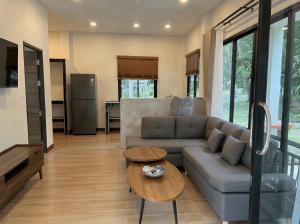 a living room with a couch and a table at Thara Bohemia Villa in Hinkong