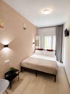 a bedroom with a large bed and a window at Casa Durán Alicante in Alicante