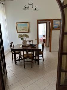a dining room with a table and chairs at Casa FERRIGNO in Portoferraio +7 photos