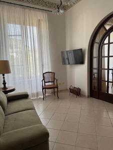 a living room with a couch and a chair at Casa FERRIGNO in Portoferraio