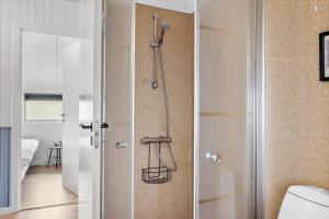 a bathroom with a shower and a toilet in a room at sj278-Bjert-Binderup-Strandpark-80 in Åbjerg +23 photos