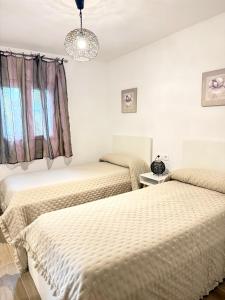 a bedroom with two beds and a window at Casa Silvestre in Puigmoreno