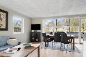 a living room with a table and chairs at SJ277-Haderslev-Kelstrup-Norreskov-36 in Haderslev