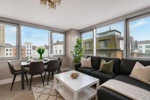 a living room with a couch and a table at Airhost's Brighton's Best Green Diamond Escape with Sea Views in Brighton & Hove