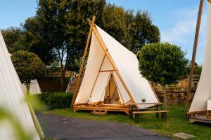 a large teepee tent sitting on the grass at Kampaoh Somo Playa in Somo