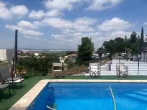 a view of a swimming pool with chairs at 3 Bed Chalet-Pool-Pets-Hot Tub-Parking-Garden in Chiva
