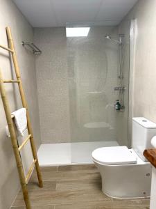 a bathroom with a shower with a toilet and a glass door at Casa Silvestre in Puigmoreno +5 photos
