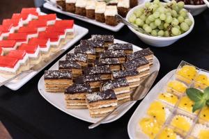 a table topped with different types of food on plates at Turówka Hotel & Spa in Wieliczka