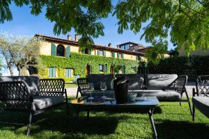 a group of chairs and a table in front of a house at Villa Santa Chiara in Siena