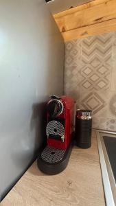 a red toaster sitting on a stand in a corner at Nota A Frame in Šakotinac