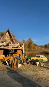 a pile of vehicles parked in front of a house at Nota A Frame in Šakotinac