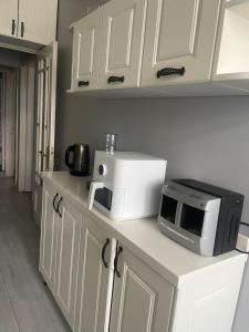 a kitchen with a microwave and a toaster oven on a counter at Apartment old Batumi in Batumi