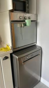 a refrigerator with a microwave on top of it at Apartment old Batumi in Batumi +24 photos