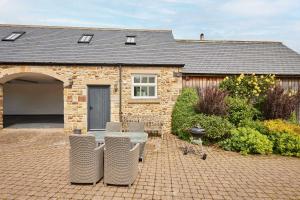 a brick house with a table and chairs in front of it at Host & Stay - The Spinney in Consett