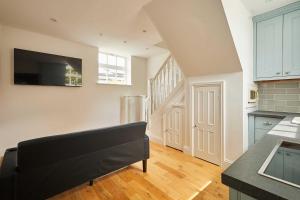 a kitchen with a black couch in a room at Host & Stay - The Spinney in Consett