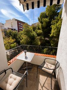 a balcony with a table and chairs on a balcony at Casa Durán Alicante in Alicante
