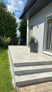 a house with a porch with a potted plant on it at StGeorge Retreat in Sângeorgiu de Mureș