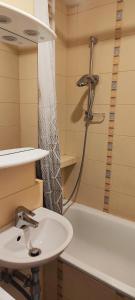 a bathroom with a sink and a shower and a tub at Rynek - Nowy Targ in Wrocław