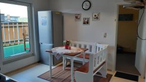 a kitchen with a small table and a refrigerator at Monteurwohnung 2 Vollumen in Redwitz an der Rodach +14 photos