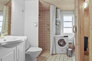 a bathroom with a toilet and a washing machine at SJ243-Haderslev-Vikaerparken-79 in Haderslev +18 photos