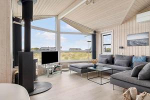 a living room with a couch and a tv at LN602-Hjorring-Harerenden-71 in Hjørring