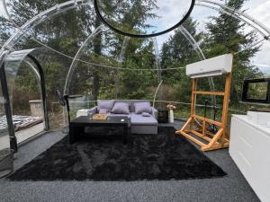 a living room with a couch and a stage at Skyhomes Bubble Hotel in Prague
