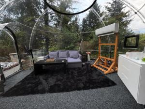 a living room with a couch in a tent at Skyhomes Bubble Hotel in Prague