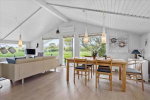a dining room and living room with a table and chairs at SJ253-Haderslev-Vikaerparken-89 in Haderslev